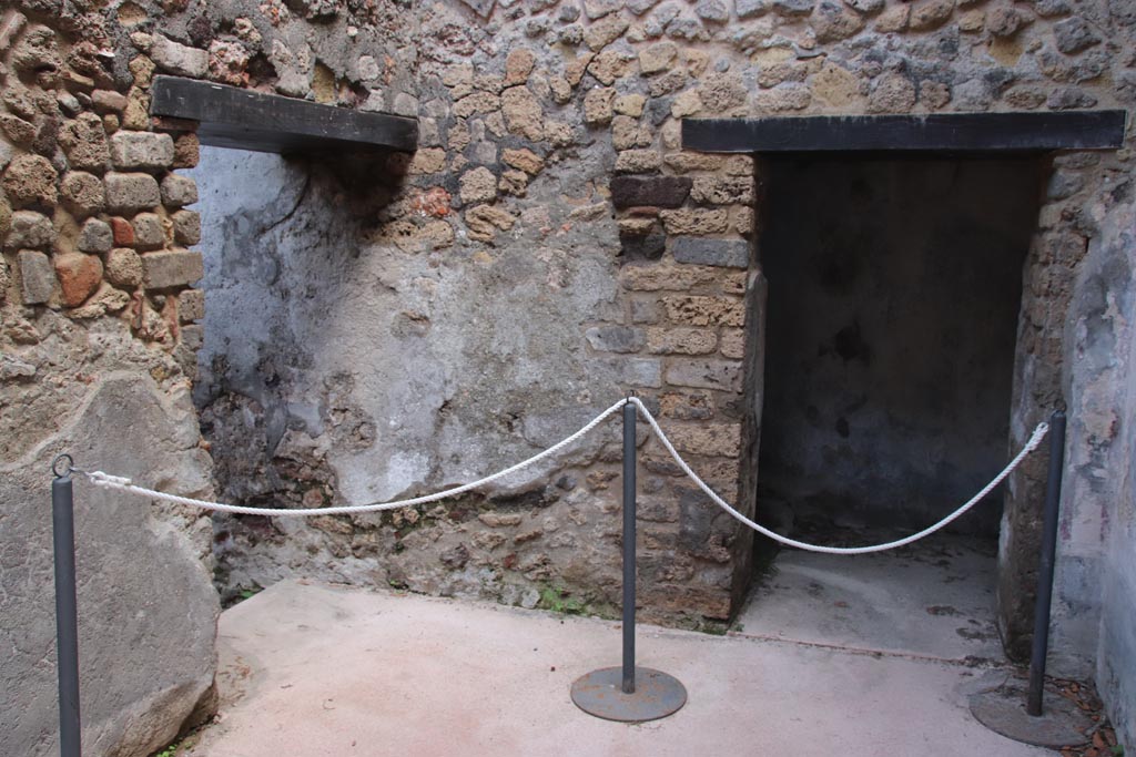 Villa of Diomedes, Pompeii. October 2023. East end of room 5,a, with doorway in east wall into room with steps to upper floor.
On the left is the turn into the corridor 5,3. Photo courtesy of Klaus Heese.