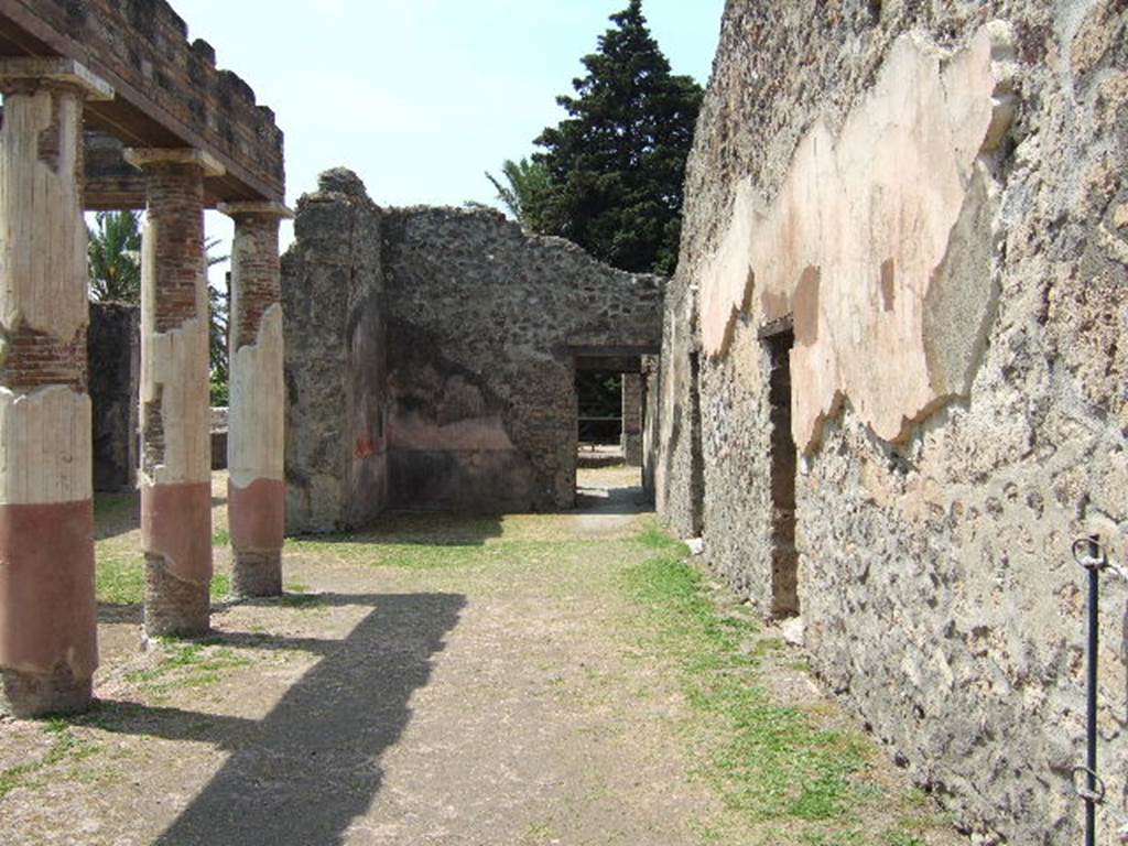 HGW24 Pompeii. May 2006. Looking west along north side of peristyle towards ala.
(Fontaine, north side of courtyard portico was numbered as 2a, the doorway (on right) is actually a niche near to which La Vega No.45, and No.8 were found.
From PAH, addendum, p.127 – (see No.45 below, on the plan by La Vega this was found along this side of the front peristyle).
Relazione delle antichita, che si vanno ritrovando nella masseria del sig. D. Giovanni Milano parsonaro, che si era principiata al di 14 Febbraro 1771. (Report of Antiquities found .....)
 “No.45. Nella stessa date. Si sono trovate due scive di bronzo, ed una grappa delle stesse.” 
“No.45. Of the same date. Two bronze parts of chest, possibly a lock or lock-bolt, and a hook (or reinforcing piece) of the same were found."
PAH addendum, p.158 - 6 Giugno 1772.
Altra bocca di cisterna simile. Vasca in mezzo al cortile, rivestita di marmo; no.43, 44, 45 pianta di La Vega.