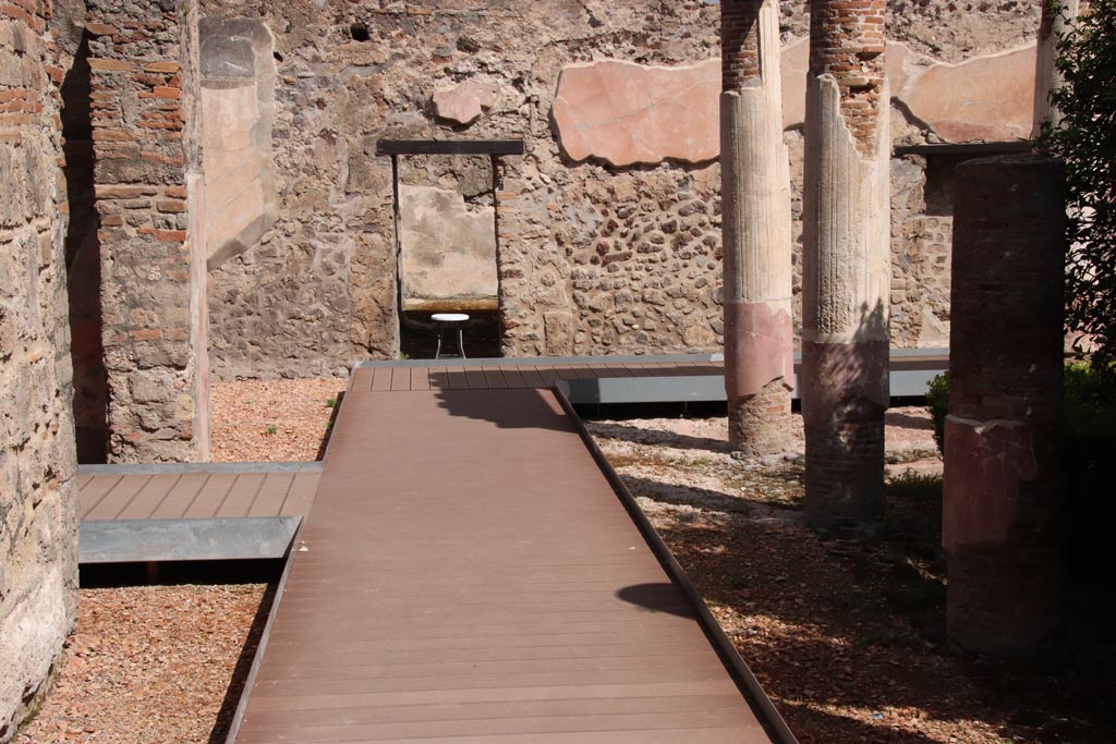 HGW24 Pompeii. Villa of Diomedes. May 2024.  
Looking towards north wall of ala, on left, and doorway to room in north-west corner of peristyle, on right. Photo courtesy of Klaus Heese.