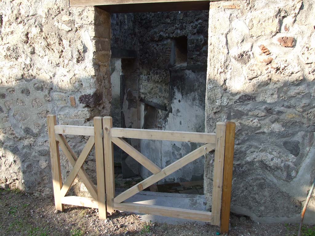 HGW24 Pompeii. December 2006. Doorway to steps to lower level. 
From PAH 1,1, p.264-5, 13th June 1772, addendum p. 127 and 158. (see Nos. 46, 47 and 48 below, on the plan by La Vega).
We have initiated the work to recognise a doorway of the aforesaid peristyle, which we believe to be the main doorway of the house, and to evacuate other rooms that were in the above apartment.
Adjoining to the same main doorway, in the internal part of the peristyle, we have dug out a stairway that leads to the lower apartments, and in the entrance we have found a lamp with a bronze wick-holder, shaped like a snail in the act of leaving his shell, and this was made to be placed in any place, having below some hardness which would hold it, or to hang from above by the form of a ring on which was attached a chain, and it was in very good condition. 
According to Pagano and Prisciandaro, the inventory number of the lamp is NAP 72261, and further information is in AdE VIII, 66, 301.
See Pagano, M. and Prisciandaro, R., 2006. Studio sulle provenienze degli oggetti rinvenuti negli scavi borbonici del regno di Napoli.  Naples: Nicola Longobardi. (p.72).
Here was also found a bronze vase/pot in the shape of a stock-pot.
At the threshold of the entrance doorway, a small ivory spoon was found (0.11m long).