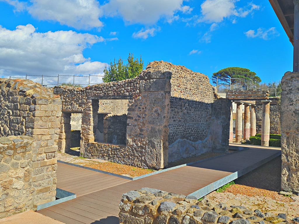 HGW24 Pompeii. Villa of Diomedes. March 2024. From area of loggia/terrace.
Doorway to corridor (2.4) and window to room (2.6), on left, on north side of tablinum, on right. Photo courtesy of Giuseppe Ciaramella.