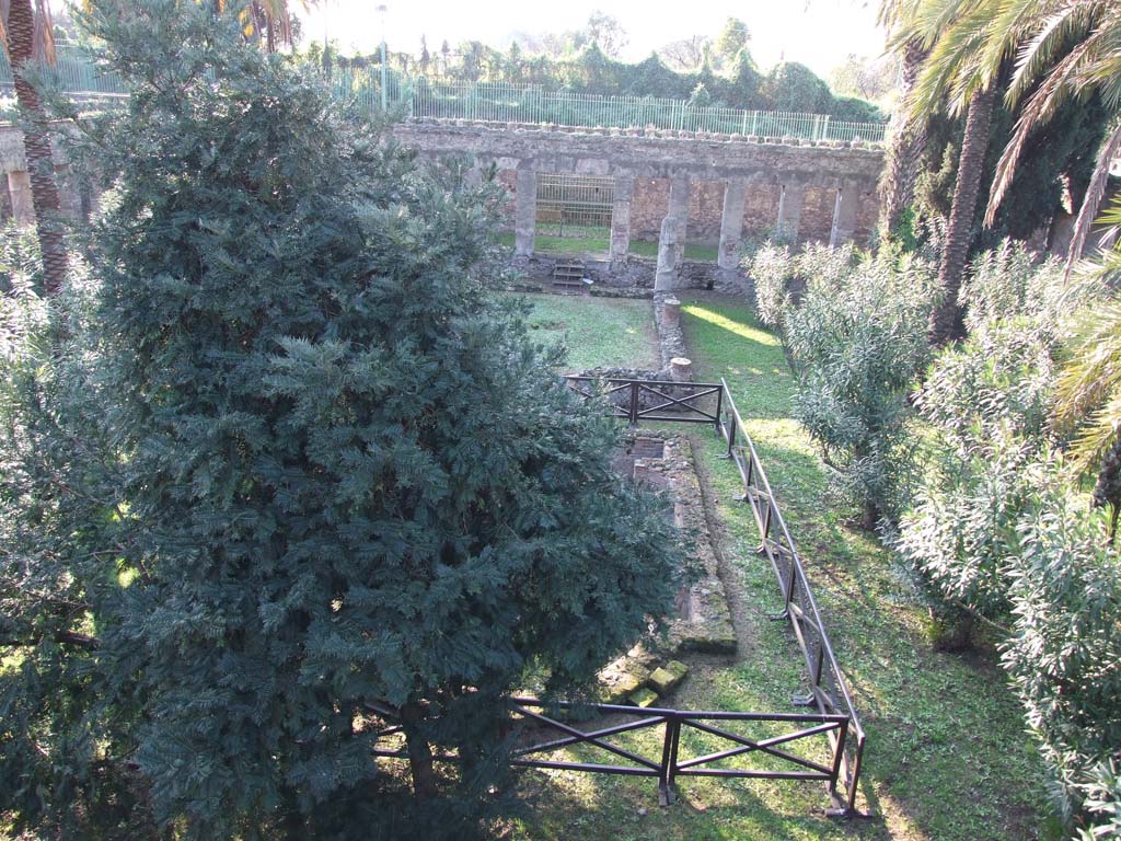 HGW24 Pompeii. December 2006. 
Looking west from area of large exedra towards the garden and the west portico in the background. 
According to Jashemski, the garden was enclosed on four sides by a portico supported by sixty-three pillars.
In the centre of the terrace above the portico on the east side was a large room.
This room had a panoramic view towards Stabia, Sorrento and the Bay of Naples.
A large apsed pool with a fountain was in the centre of the garden.
See Jashemski, W. F., 1993. The Gardens of Pompeii, Volume II: Appendices. New York: Caratzas. (p.281)