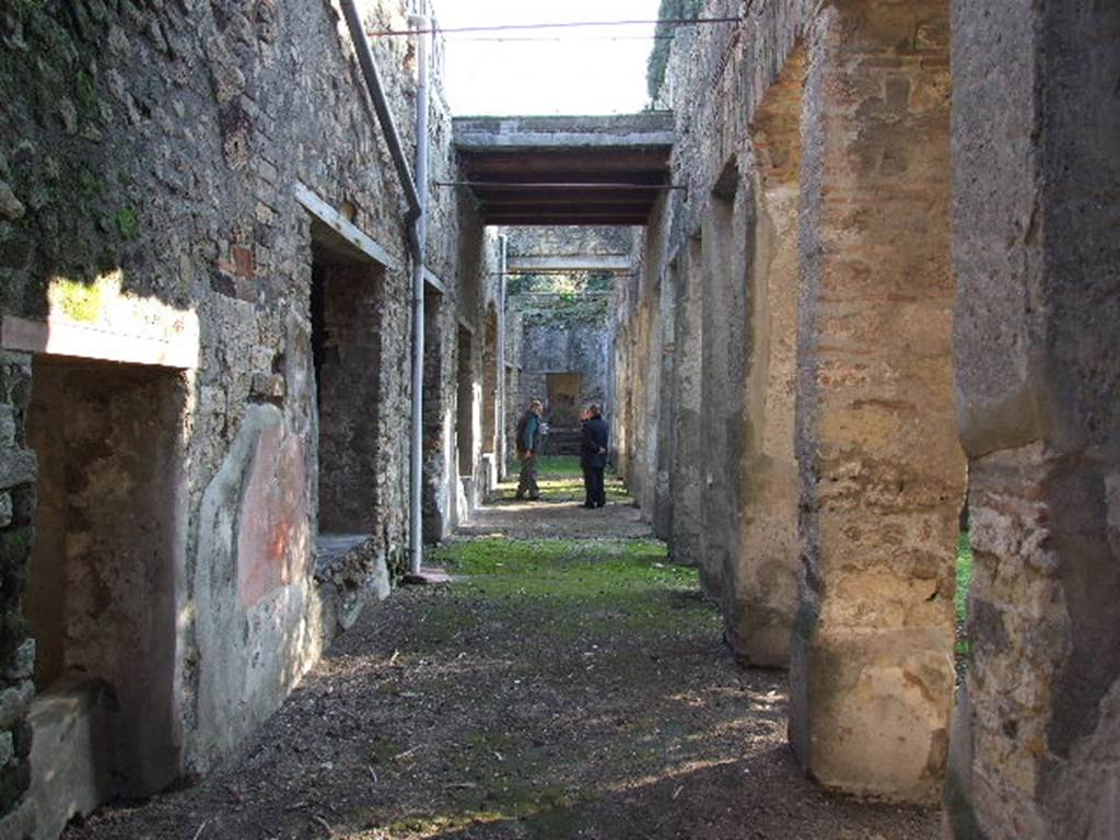 HGW24 Pompeii. December 2006. Looking south along the east portico. The area of the loggia above can be seen in the centre of the photo.
According to the plan of La Vega, no.38 would have been found on the lower right of the photo, in the east portico. (North end of east garden portico).
52 and 53 would have been found under the area of the loggia, centre of photo, in the east portico.
84 would have been found approximately where the figures are standing, in the east portico.
(Fontaine, 5e, east side of garden portico.)