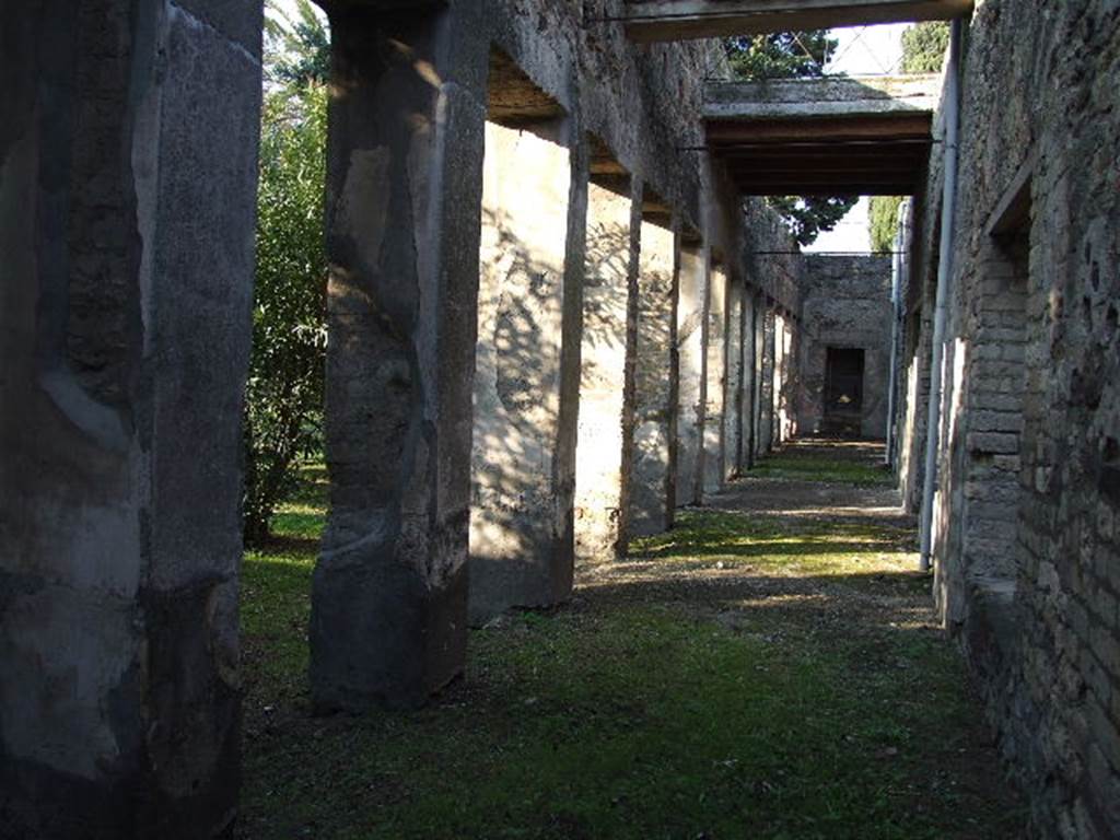 HGW24 Pompeii. December 2006. Looking north along the east portico. 
On the west side of the east portico, on the left in the garden area, nos. 89, 54 and 77 (from the La Vega plan) would have been found.