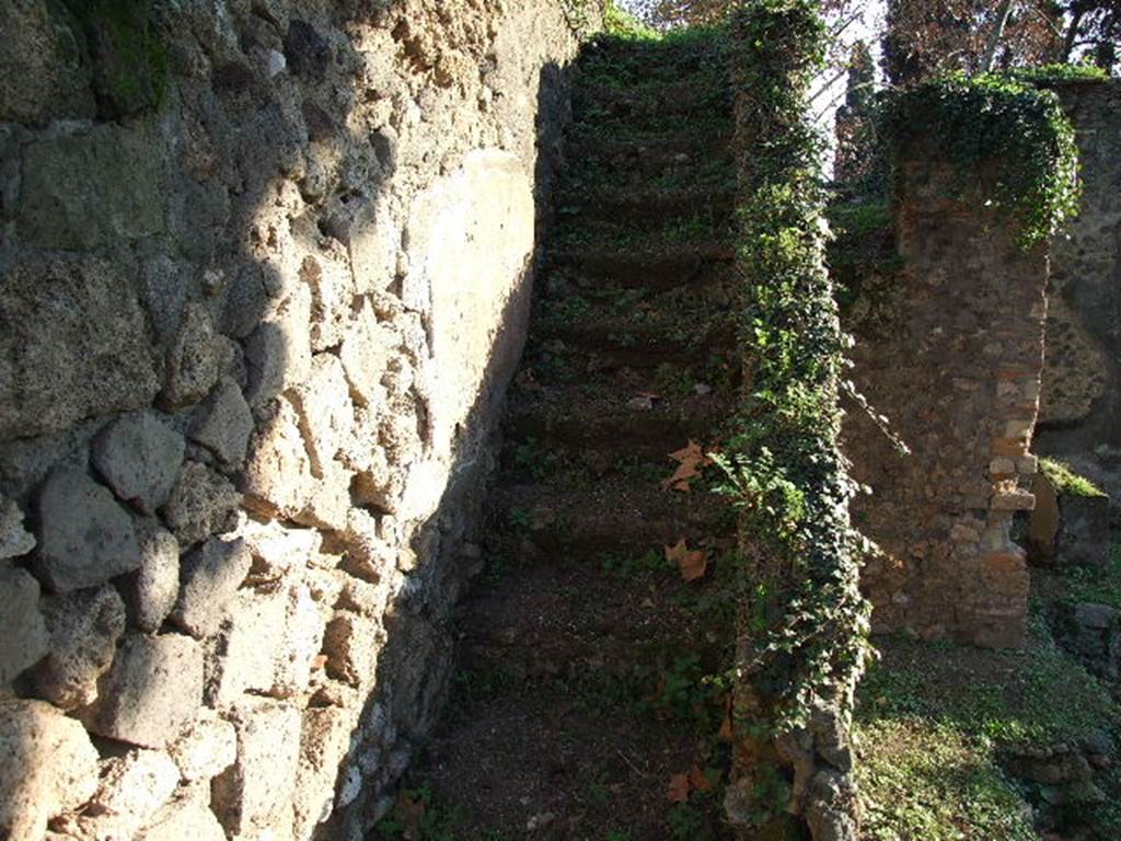 HGE12 Pompeii. December 2006. Staircase against east wall of courtyard with lararium.