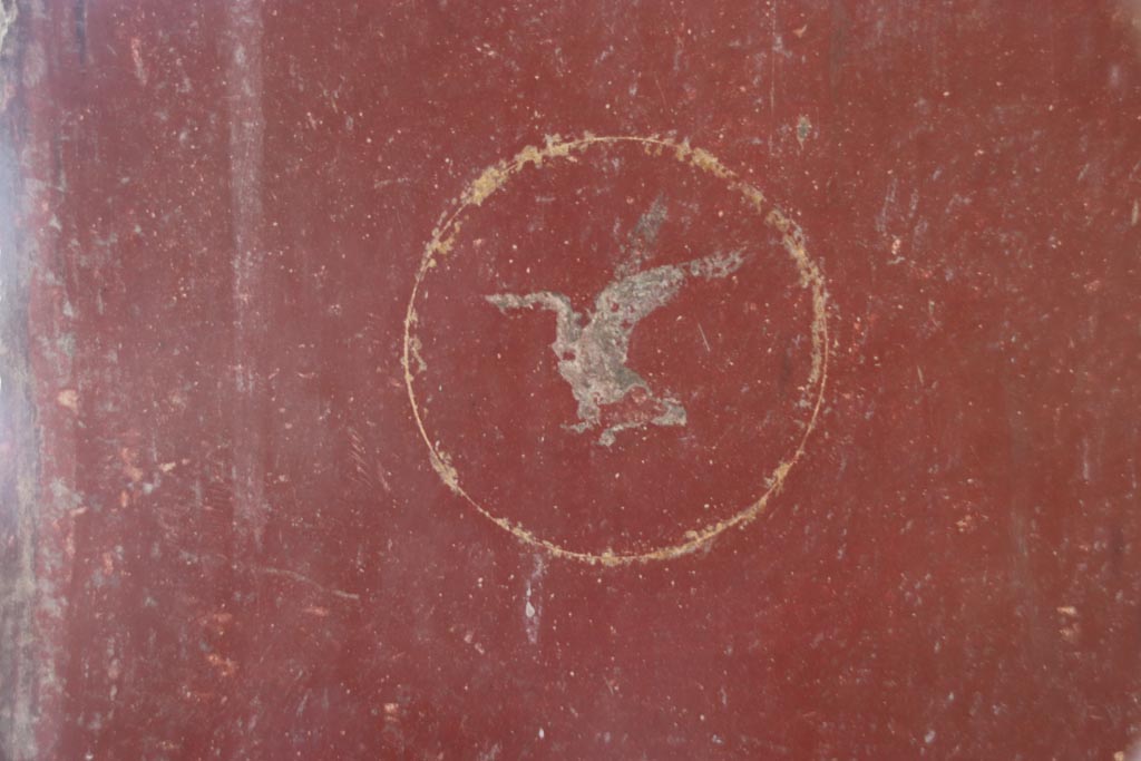 Villa San Marco, Stabiae, October 2022. 
Room 8, detail of swan in centre of red panel below figure to right of window on east wall. Photo courtesy of Klaus Heese.