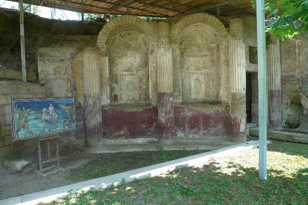 Villa San Marco, Stabiae, July 2010. 
Area 65 at southern end of peristyle garden with curving wall of a nymphaeum, divided into eight niches.
On the right is the doorway to area 63. Photo courtesy of Michael Binns.