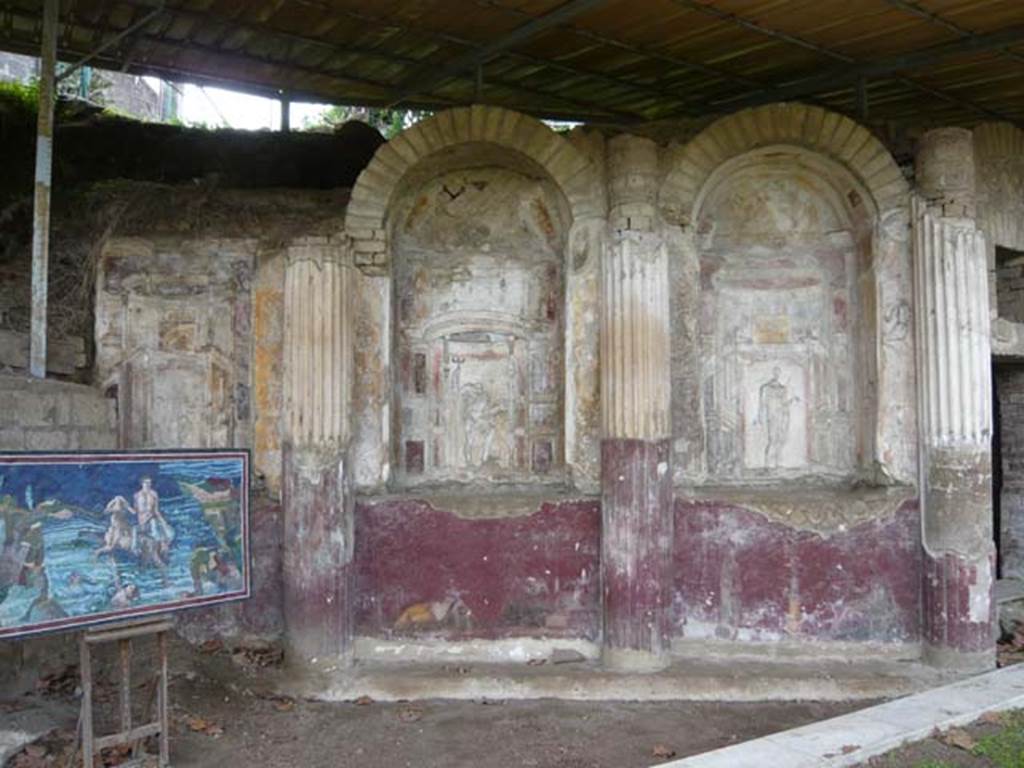 Villa San Marco, Stabiae, 2010. Room 65, at southern end of peristyle garden, with curving wall of the nymphaeum. 
Three niches with stuccoes of (right to left) Venus, Neptune and Fortuna. 
Under the niches are paintings of (right to left)
- Two people, one on either side of a thymiaterion (incense burner), making offerings
- Narcissus and Echo
- Tripod and person making an offering
Photo courtesy of Buzz Ferebee.
See Barbet A. (a cura di), 1999. La Villa San Marco di Stabia: Illustrazioni 1. Roma, L’Erma di Bretschneider, pl. V.