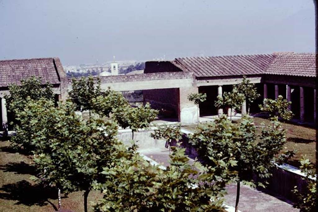 Villa San Marco, Stabiae, 1976. Looking north-east across garden area 9 to oecus 16 and north portico 5. 
Photo by Stanley A. Jashemski.   
Source: The Wilhelmina and Stanley A. Jashemski archive in the University of Maryland Library, Special Collections (See collection page) and made available under the Creative Commons Attribution-Non Commercial License v.4. See Licence and use details.
J76f0495