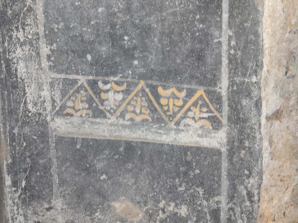 Villa San Marco, Stabiae, June 2019. Room 44, painted decoration on black zoccolo on east side of entrance doorway.
Photo courtesy of Buzz Ferebee.