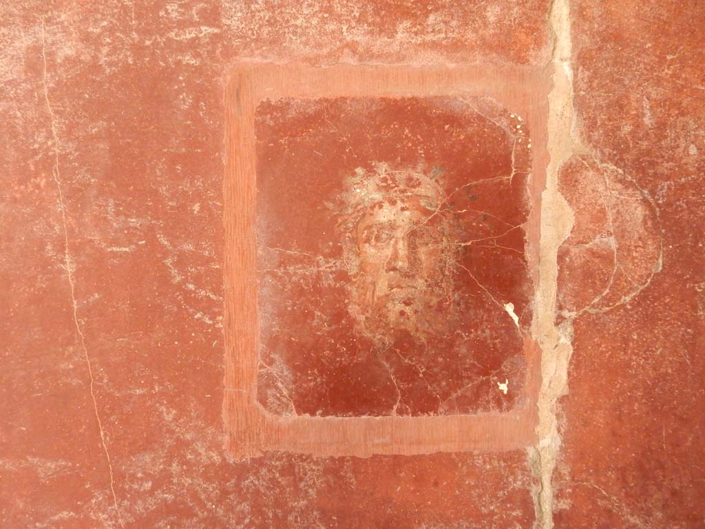 Villa San Marco, Stabiae, June 2019. Room 44, detail of painted face from east wall in south-east corner.
Photo courtesy of Buzz Ferebee.