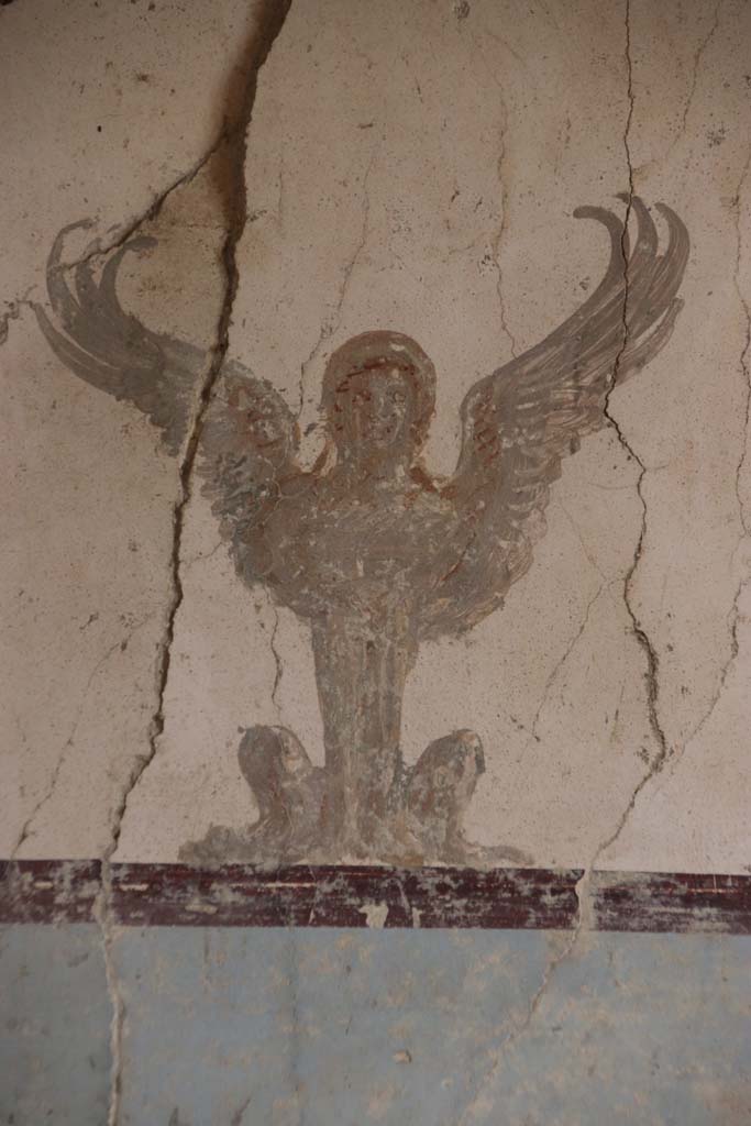 Villa San Marco, Stabiae, September 2019. Room 57, detail of painting of sphynx at top of centre panel of east wall. 
Photo courtesy of Klaus Heese.
