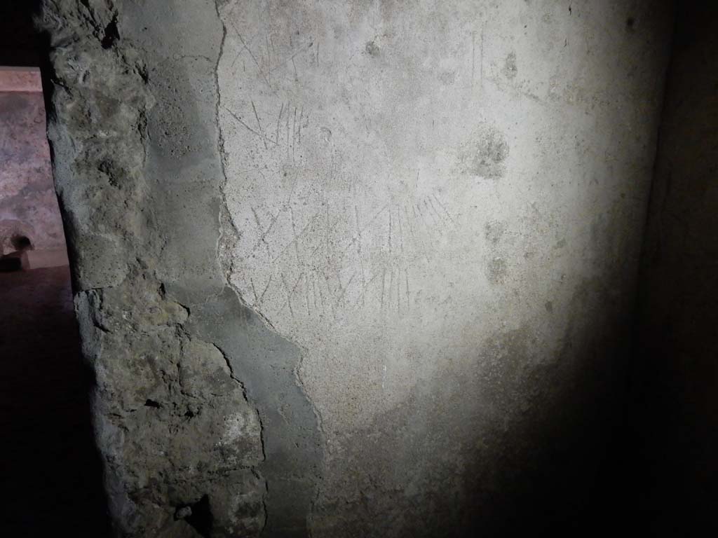 Villa San Marco, Stabiae, June 2019. Room 26, graffiti of Roman numerals on south wall in south-west corner of kitchen.
 Photo courtesy of Buzz Ferebee