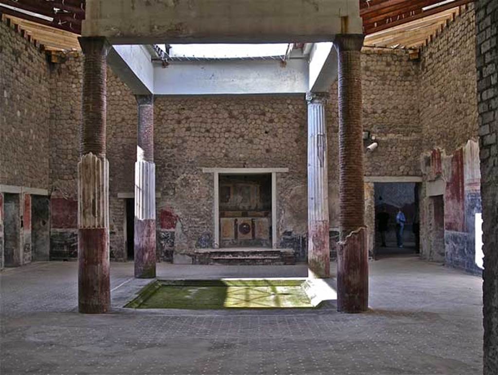 Villa San Marco, Stabiae, April 2005. Looking west across atrium 44, the doorway to corridor 32 is on the right of the lararium. The small doorway leading to room 31 is on the right.
Photo courtesy of Michael Binns.