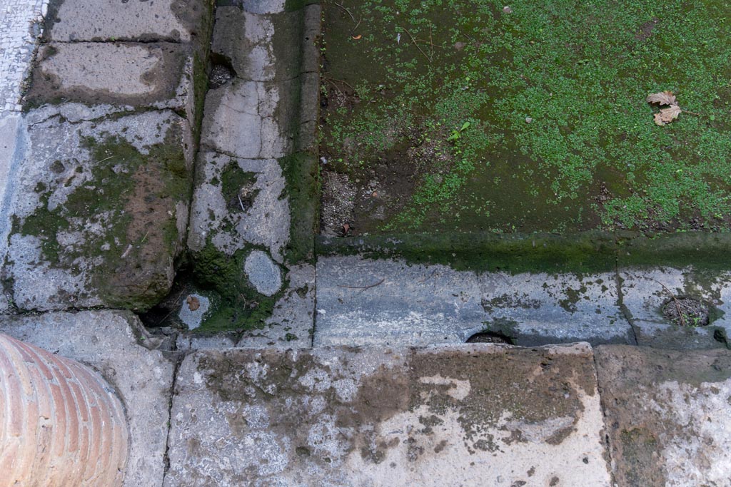 Villa of Mysteries, Pompeii. October 2023. 
Looking towards north-east corner of impluvium, with gutter. Photo courtesy of Johannes Eber.