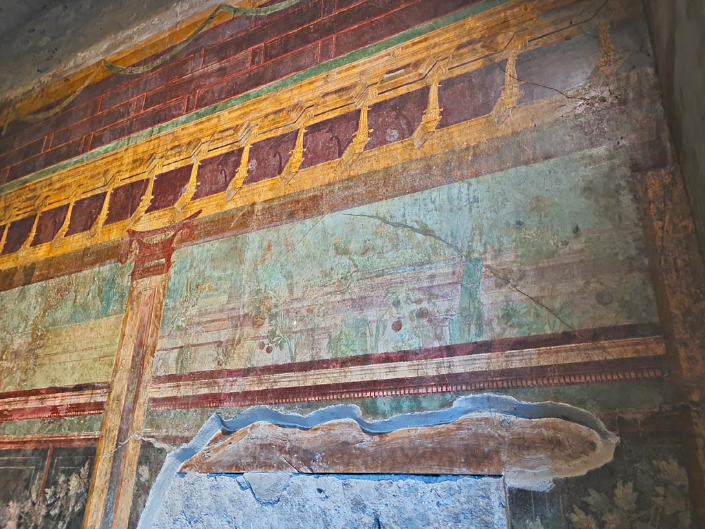 Villa of Mysteries, Pompeii. November 2023. 
Room 6, east wall, painted detail from above blocked doorway. Photo courtesy of Giuseppe Ciaramella.