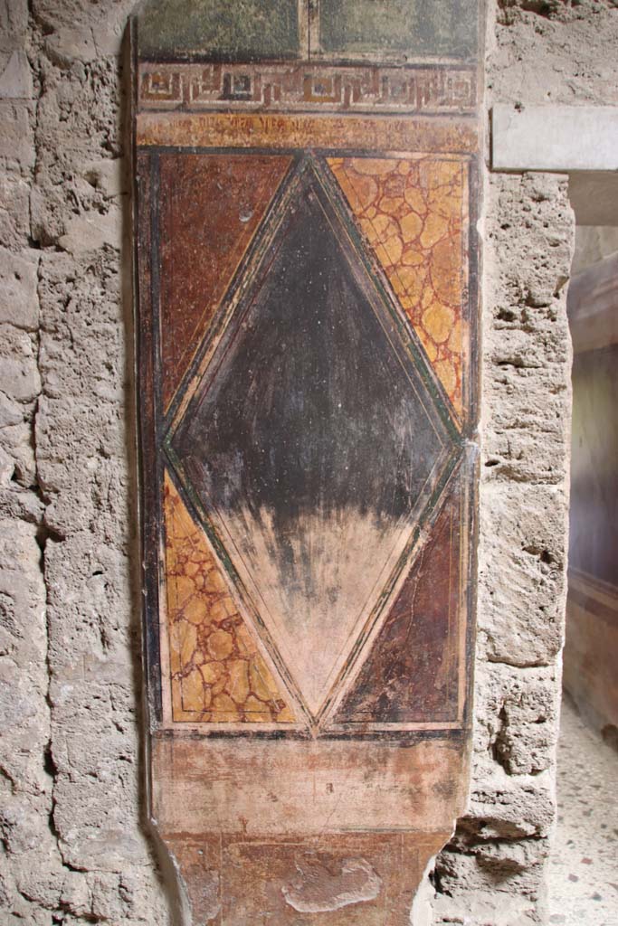 Villa of Mysteries, Pompeii. September 2021. 
Room 64, detail of wall decoration on north wall next to corridor F2. Photo courtesy of Klaus Heese.