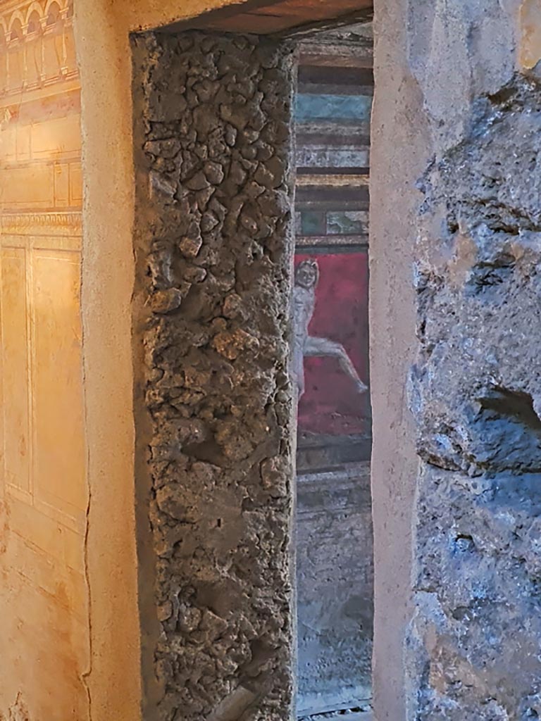 Villa of Mysteries, Pompeii. November 2023. 
Room 3, looking through doorway into room 4, with detail of wall. Photo courtesy of Giuseppe Ciaramella.