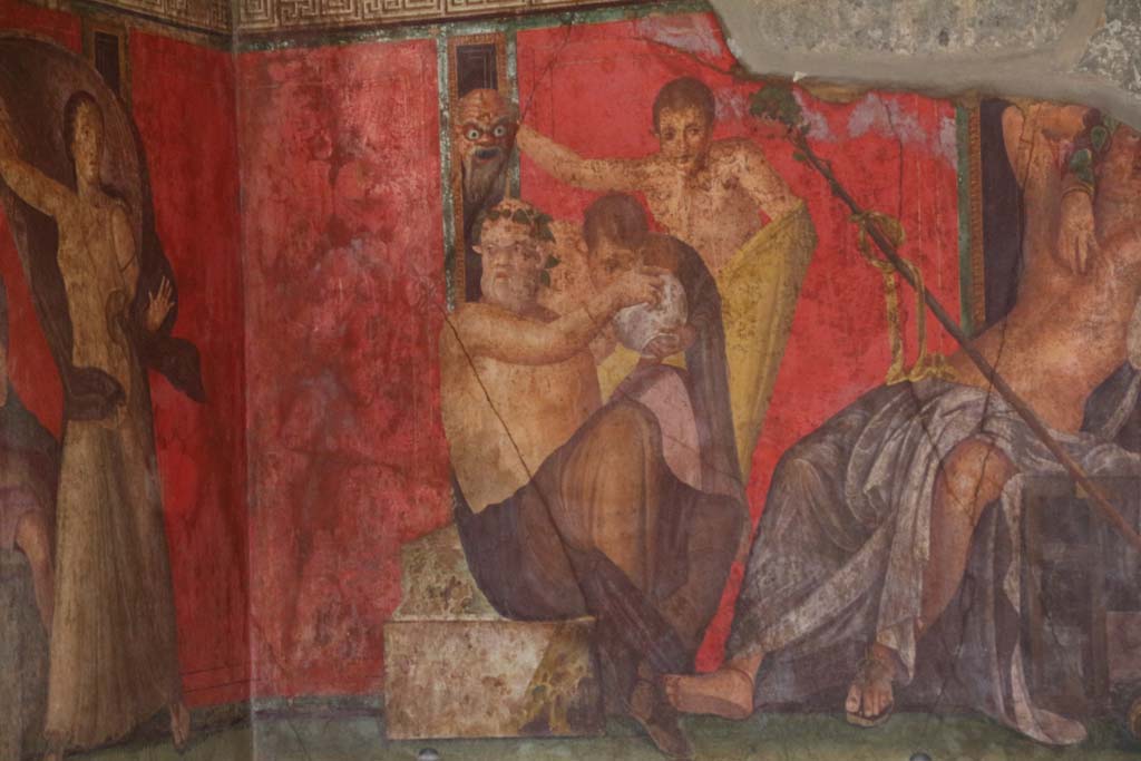 Villa of Mysteries, Pompeii. April 2014. 
Room 5, a Silenus and satyrs, theatrical mask in hand, consume wine, detail from east wall of painting of Dionysian mystery, in north-east corner. 
Photo courtesy of Klaus Heese.