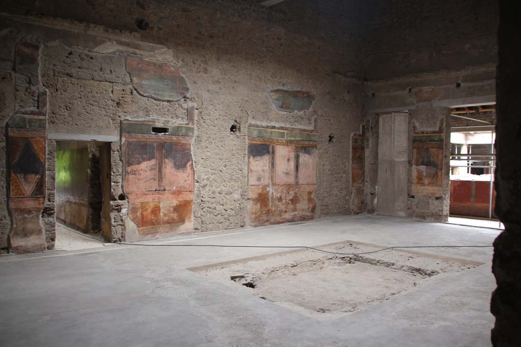 Villa of Mysteries, Pompeii. April 2014. Room 64, looking towards north wall of atrium and north-east corner. 
The doorway to corridor F2 can be seen on the left, on the right is the doorway to the peristyle. 
Photo courtesy of Klaus Heese.