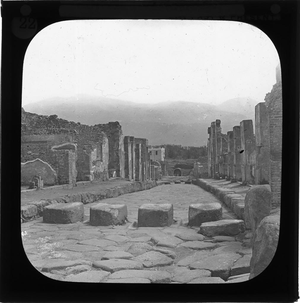Via Stabiana, Pompeii. Glass lantern slide by York and Son, in or before 1890. 
Looking south from Holconius crossroads, between I.4 on left, and VIII.4 on right.
Photo by permission of the Institute of Archaeology, University of Oxford. File name Passmorebx9im 029. Resource ID. 36561. 
See photo on University of Oxford HEIR database