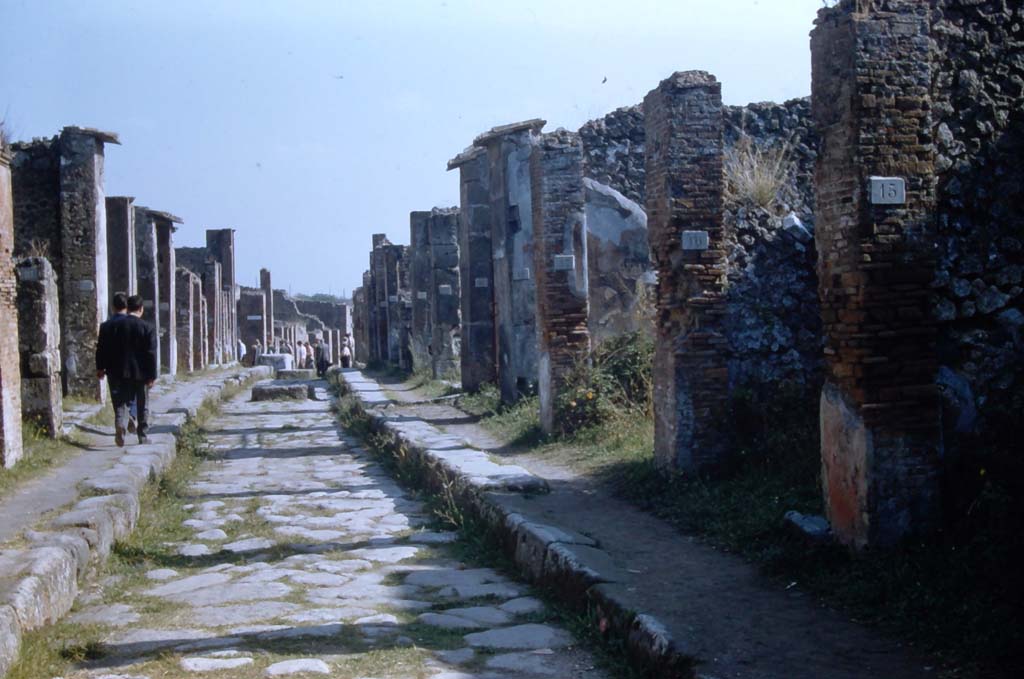 Via degli Augustali, Pompeii. November 1961. 
Looking east towards crossroads/junction with Vico Storto and Vicolo di Eumachia. Photo courtesy of Rick Bauer.