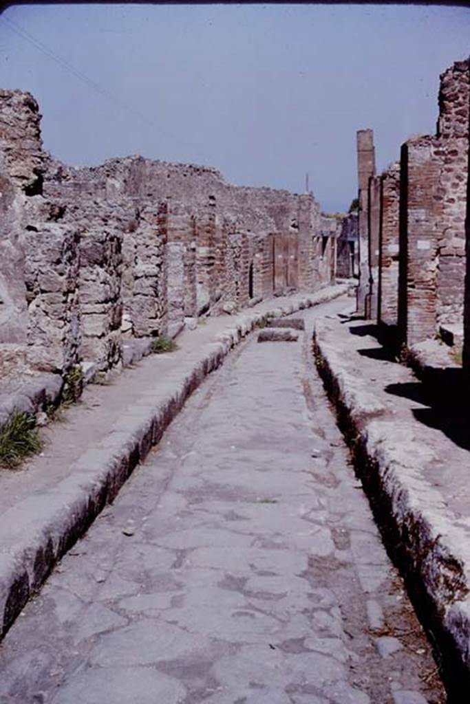 Via degli Augustali. Pompeii. 1966. Looking east at roadway surface and wheel ruts worn by traffic.  Photo by Stanley A. Jashemski.
Source: The Wilhelmina and Stanley A. Jashemski archive in the University of Maryland Library, Special Collections (See collection page) and made available under the Creative Commons Attribution-Non Commercial License v.4. See Licence and use details.
J66f1014