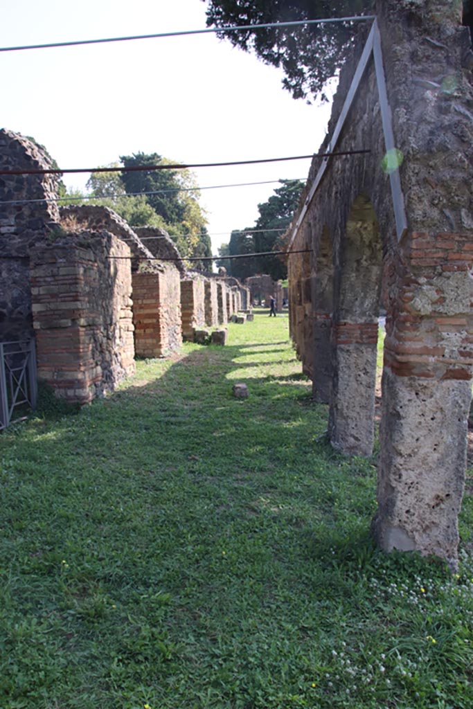 Via dei Sepolcri, east side, Pompeii. October 2023. 
Looking south along colonnade of portico. Photo courtesy of Klaus Heese.