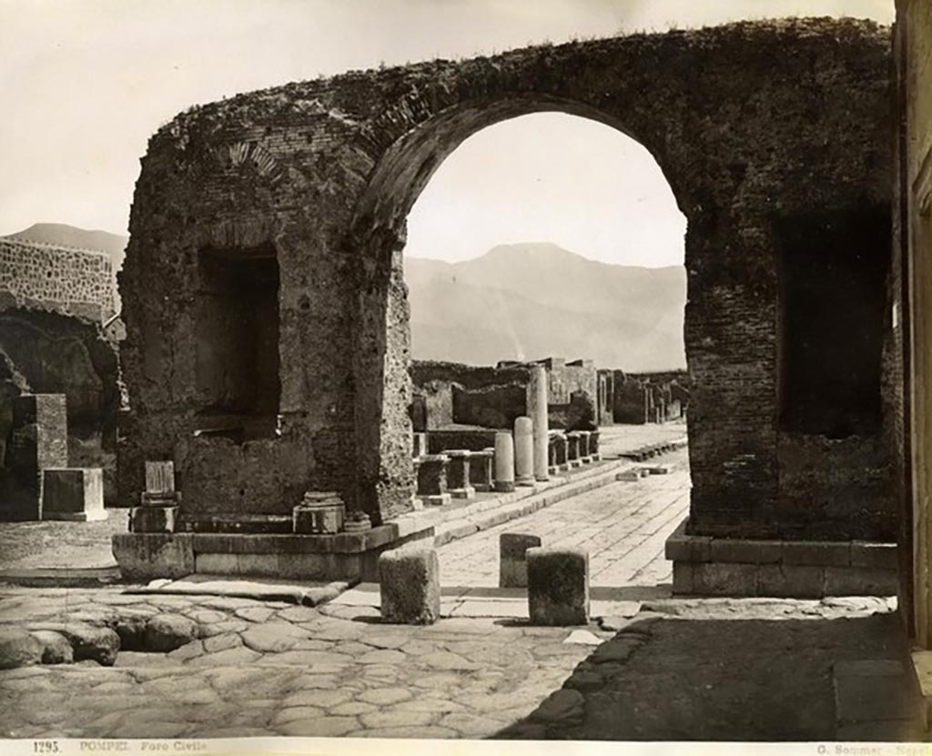 Forum arch at south end of Via Foro. Looking south through arch towards east side of Forum.
Photograph No. 1295, by Giorgio Sommer (1834-1914). Public domain, via Wikimedia Commons