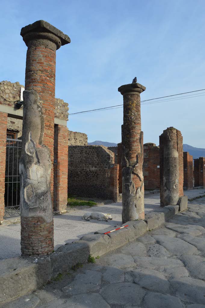 Via del Foro, east side, Pompeii. March 2019. 
Looking south-east towards third and second column from south end with pilaster/column at south end, on right, outside VII.4.12. 
Foto Taylor Lauritsen, ERC Grant 681269 DÉCOR.