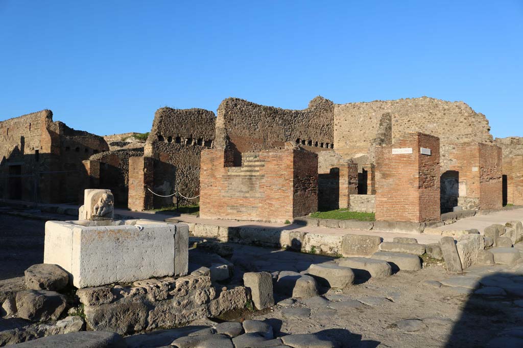 Via del Vesuvio, Pompeii. December 2018. 
Looking north-east towards V.1.1/32 on the east side of the junction with Via del Vesuvio, and Via di Nola, on right. Photo courtesy of Aude Durand.