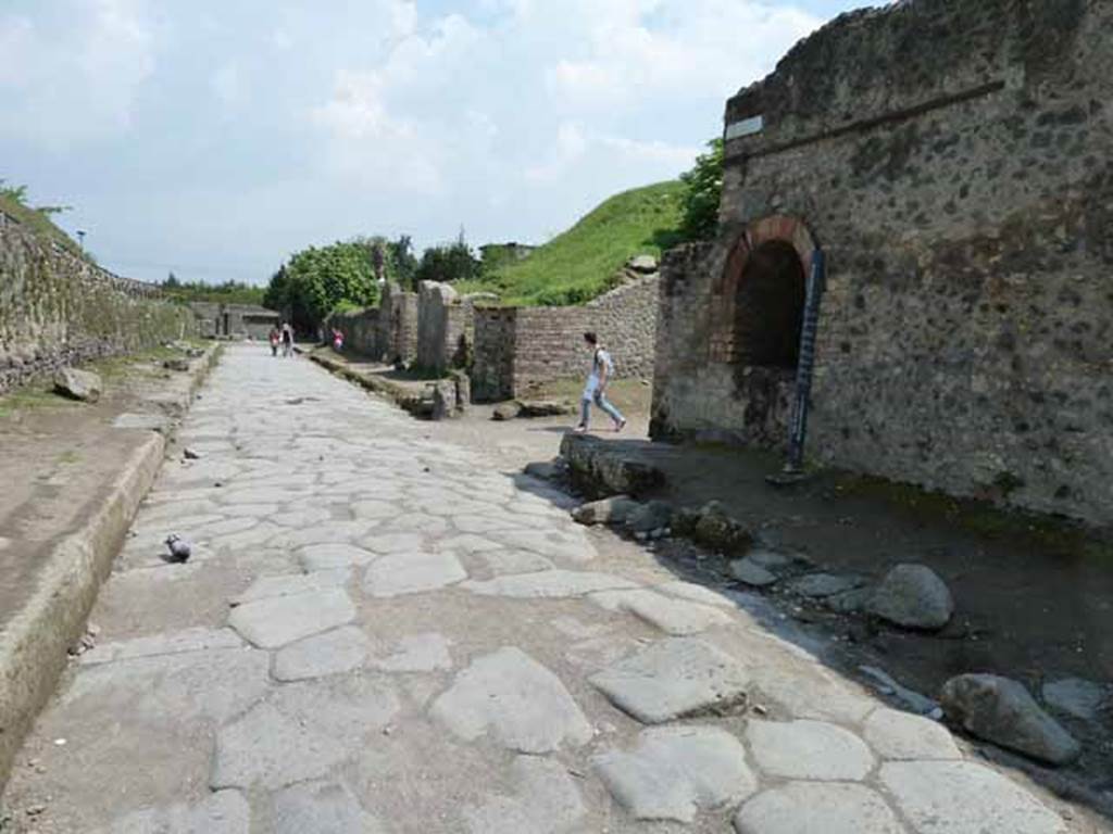 Via dell’Abbondanza, Pompeii. May 2010. 
Looking east along III.7 on north side of Via dell’Abbondanza with II.4 and II.5 and Vicolo dell’Anfiteatro on right.