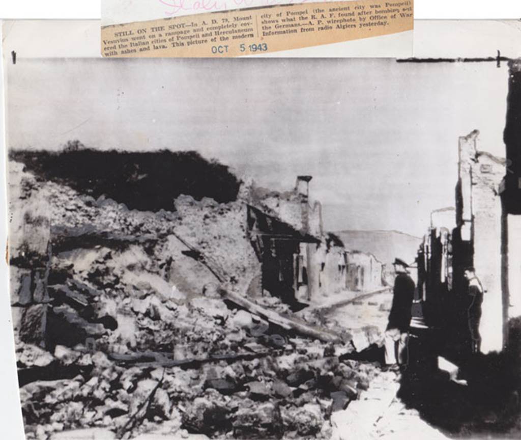 Via dell’Abbondanza Pompeii. October 1943. Looking east between IX.12 and I.8.
Picture that according to the newspaper report “shows what the RAF found after bombing.....”.  The destroyed Houses of the Cenacoli Colonnati, following the aerial bombardment of 1943.  Photo courtesy of Drew Baker.
The left pilaster of the front façade of IX.12.1 can be seen on the left.