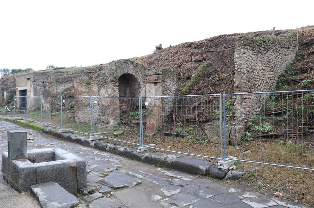 Via dell’Abbondanza, north side. December 2018.  
Looking west along insula III.6, from near III.6.6 & unexcavated roadway, on right. Photo courtesy of Aude Durand.