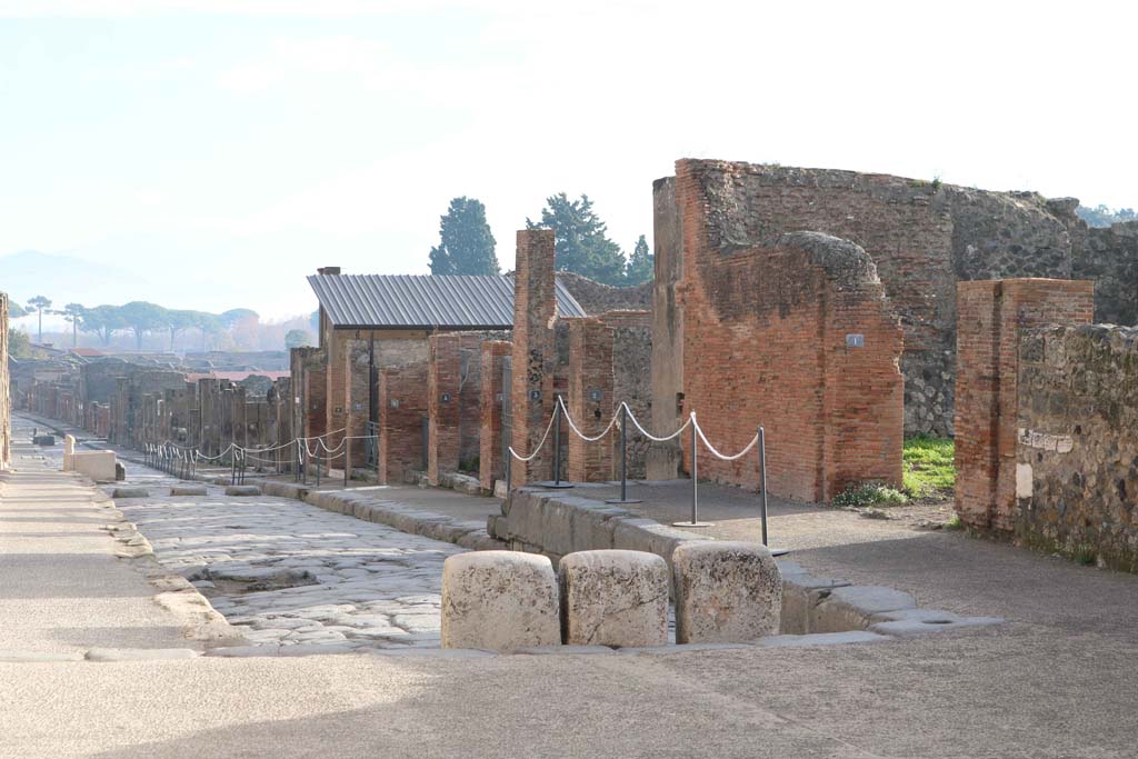 Via dell’Abbondanza, south side, Pompeii. December 2018. 
Looking south-east, from east side of Forum, towards north side of Insula VIII.3. Photo courtesy of Aude Durand.
