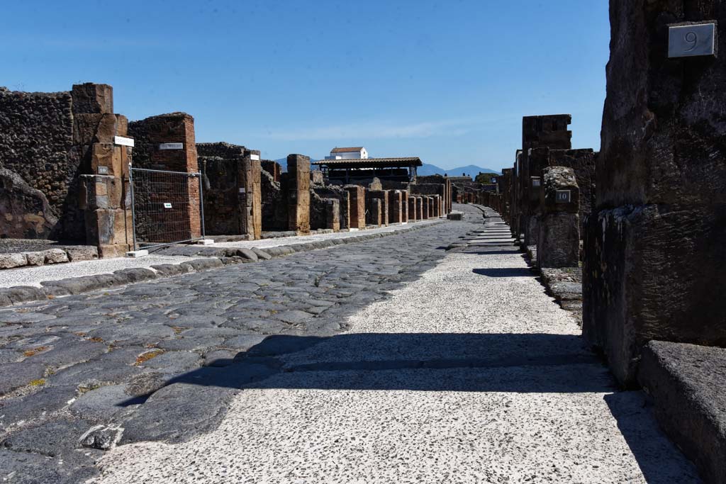 Via dell’Abbondanza, north side. April 2021. 
Looking east to VII.13.10, on left, junction with Vicolo della Maschera, and insula VII.14. Photo courtesy of Nicolas Monteix.