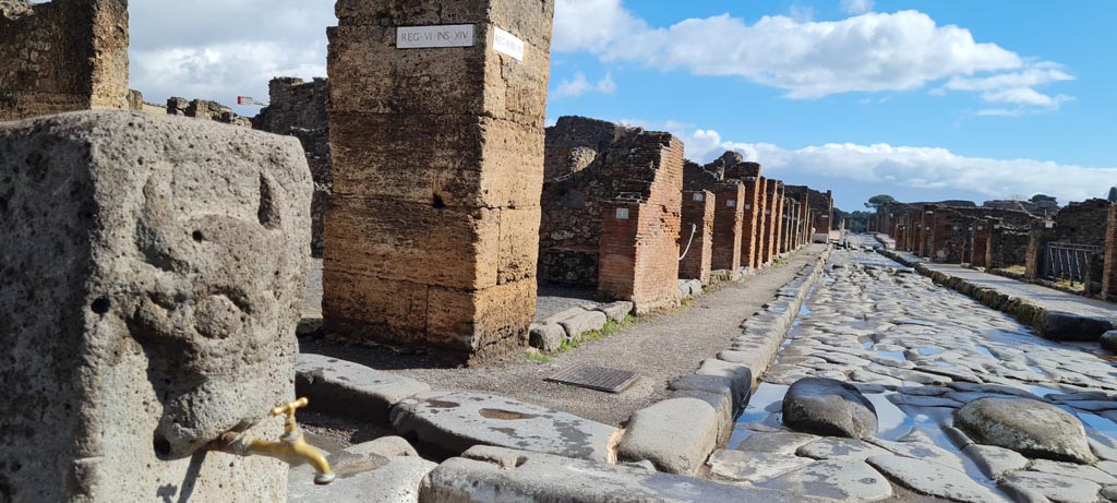 Via della Fortuna, north side, April 2022. 
Looking east from fountain at junction with Vicolo dei Vettii towards VI.14. Photo courtesy of Giuseppe Ciaramella.