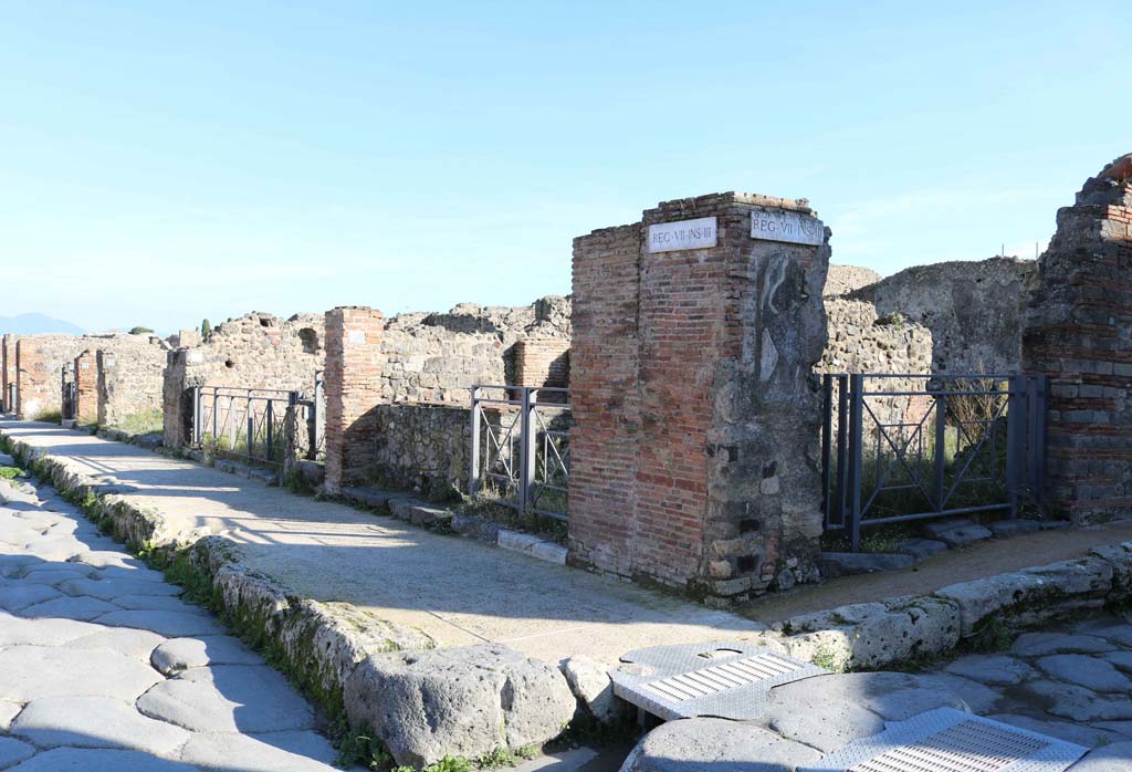 Via della Fortuna, south side, on left, Pompeii. December 2018. 
Looking south-east from junction with Vicolo Storto, on right, and along VII.3. Photo courtesy of Aude Durand.