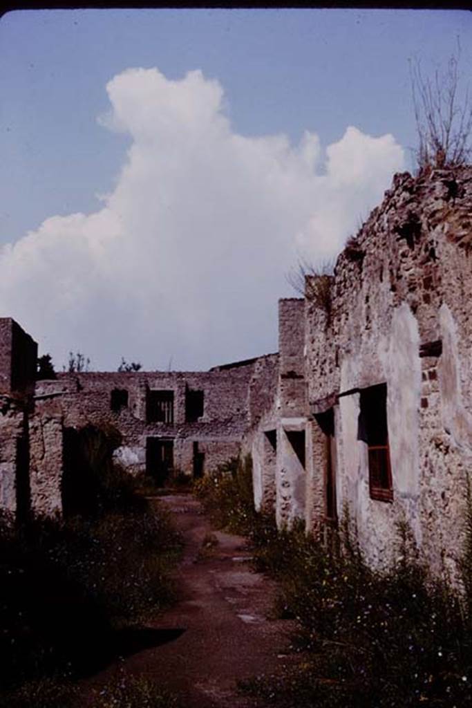 Via di Castricio, Pompeii. 1964. 
Looking west towards junction with Vicolo di Paquius Proculus, from between I.19/I.18, on left and I.7/I.8, on right.
Photo by Stanley A. Jashemski.
Source: The Wilhelmina and Stanley A. Jashemski archive in the University of Maryland Library, Special Collections (See collection page) and made available under the Creative Commons Attribution-Non-Commercial License v.4. See Licence and use details.
J64f1940