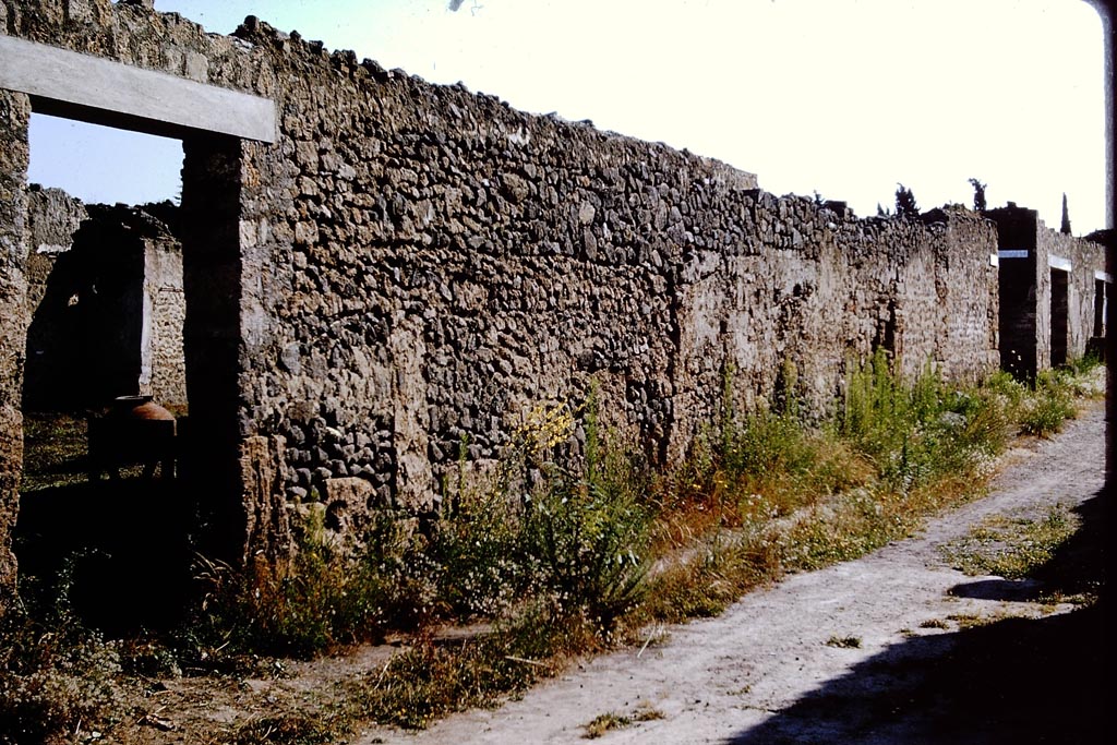 Via di Castricio, north side, Pompeii. 1964. 
Looking east along north side, with I.11.10 doorway, on left. Photo by Stanley A. Jashemski.
Source: The Wilhelmina and Stanley A. Jashemski archive in the University of Maryland Library, Special Collections (See collection page) and made available under the Creative Commons Attribution-Non-Commercial License v.4. See Licence and use details.
J64f1524