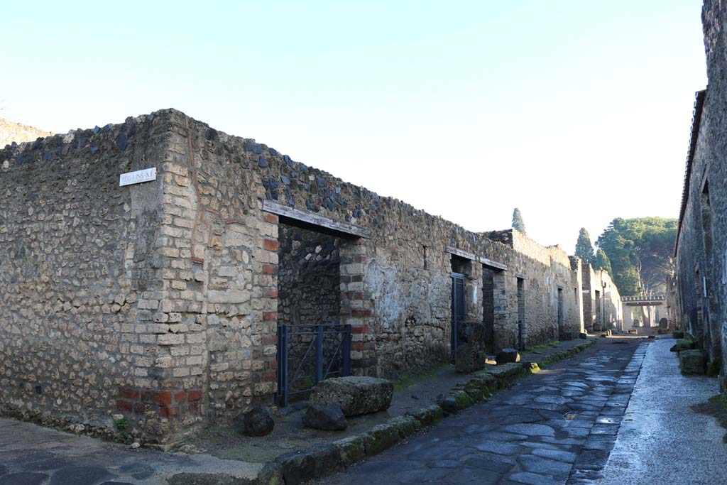 Via di Castricio, north side, December 2018. 
Looking east between I.12.12 and I.12.8, from junction with Vicolo della Nave Europa. Photo courtesy of Aude Durand.