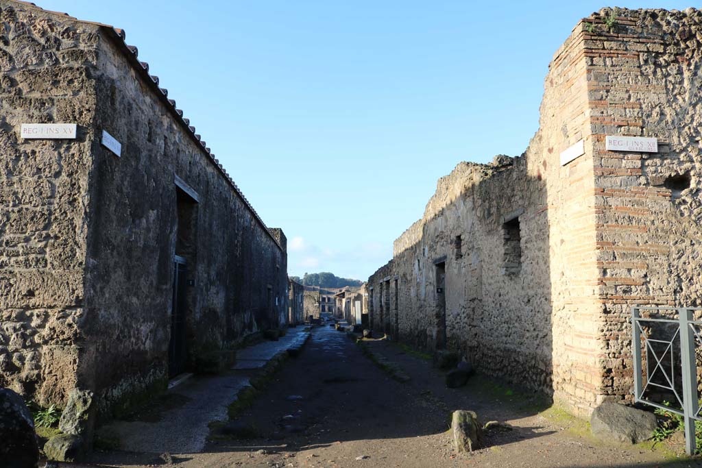 Via Castricio,Pompeii. December 2018. 
Looking west between I.15 and 1.12, from the junction with Vicolo dei Fuggiaschi. Photo courtesy of Aude Durand.