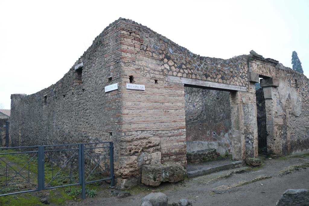 Via di Castricio, Pompeii. December 2018. 
Looking north towards east side of Vicolo dei Fuggiaschi and I.13.13/12 from junction with Via di Castricio. Photo courtesy of Aude Durand.