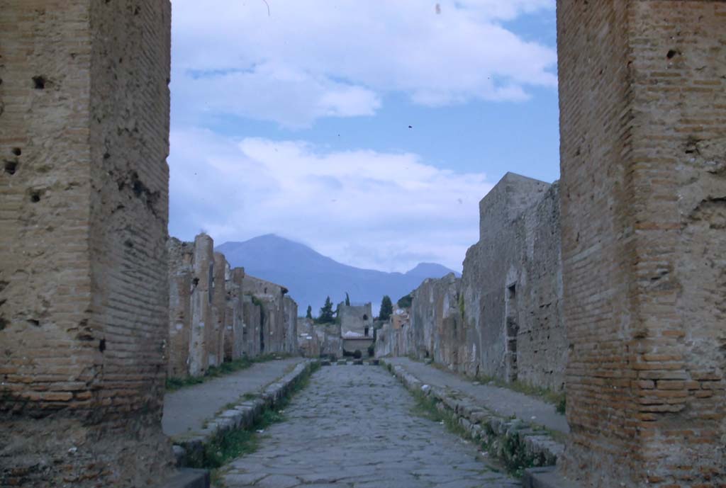 Via di Mercurio, Pompeii. November 1958. Looking north through Arch towards Tower XI, and Vesuvius. 
Photo courtesy of Rick Bauer.