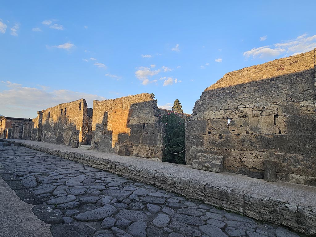 Via di Mercurio, east side, Pompeii. November 2024. 
Looking north towards doorway at VI.10.8, in centre, with VI.10.7, centre left. Photo courtesy of Annette Haug.