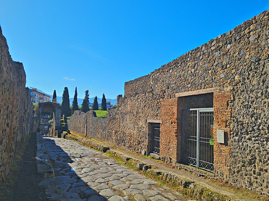 Via di Nocera, Pompeii, west side. October 2024. 
Looking south-west towards small doorway to I.20.1, in centre, and I.20.2, on right. Photo courtesy of Giuseppe Ciaramella.