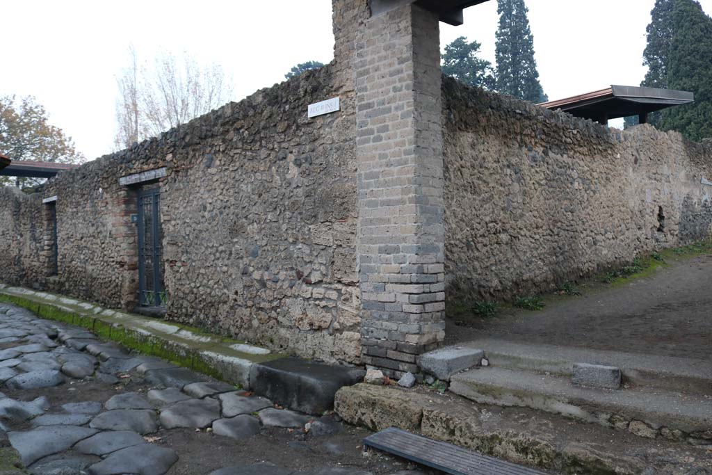 Via di Nocera, east side, Pompeii. December 2018. 
Looking north-east towards entrance doorways of II.1.10 and II.1.9, at junction with Via di Castricio, on right. Photo courtesy of Aude Durand.