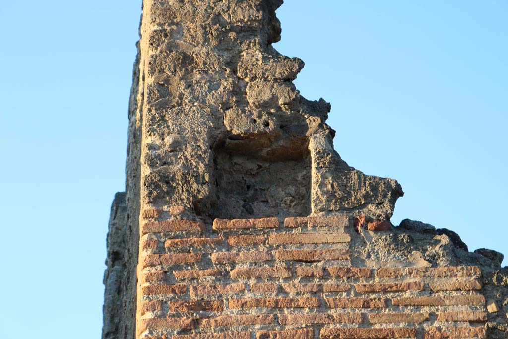 Via di Nola, Pompeii. December 2018. 
Detail of niche/recess high on south-west corner of insula on front façade of V.2.1 on Via di Nola. Photo courtesy of Aude Durand.