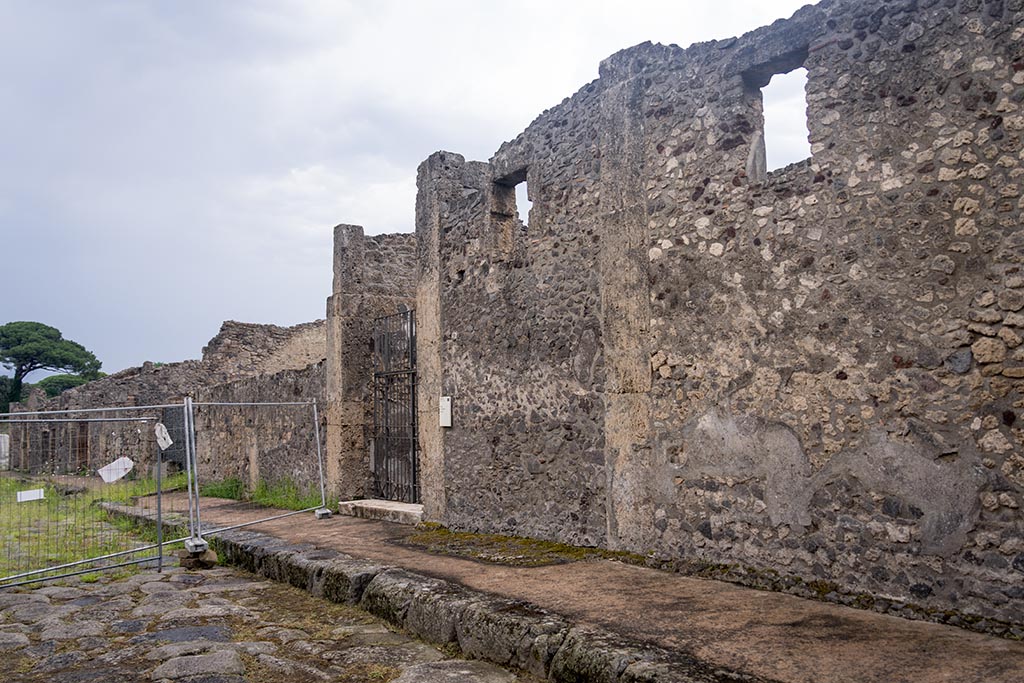 Via di Nola, south side, Pompeii. July 2024. 
Looking east along front façade towards entrance doorway of IX.14.4. Photo courtesy of Johannes Eber.