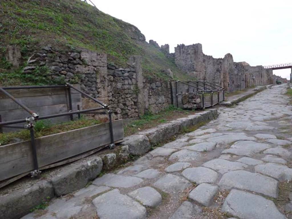 Via di Nola, south side. September 2011. Looking west from near III.9.3, towards unexcavated vicolo, and III.8. Photo courtesy of Michael Binns.